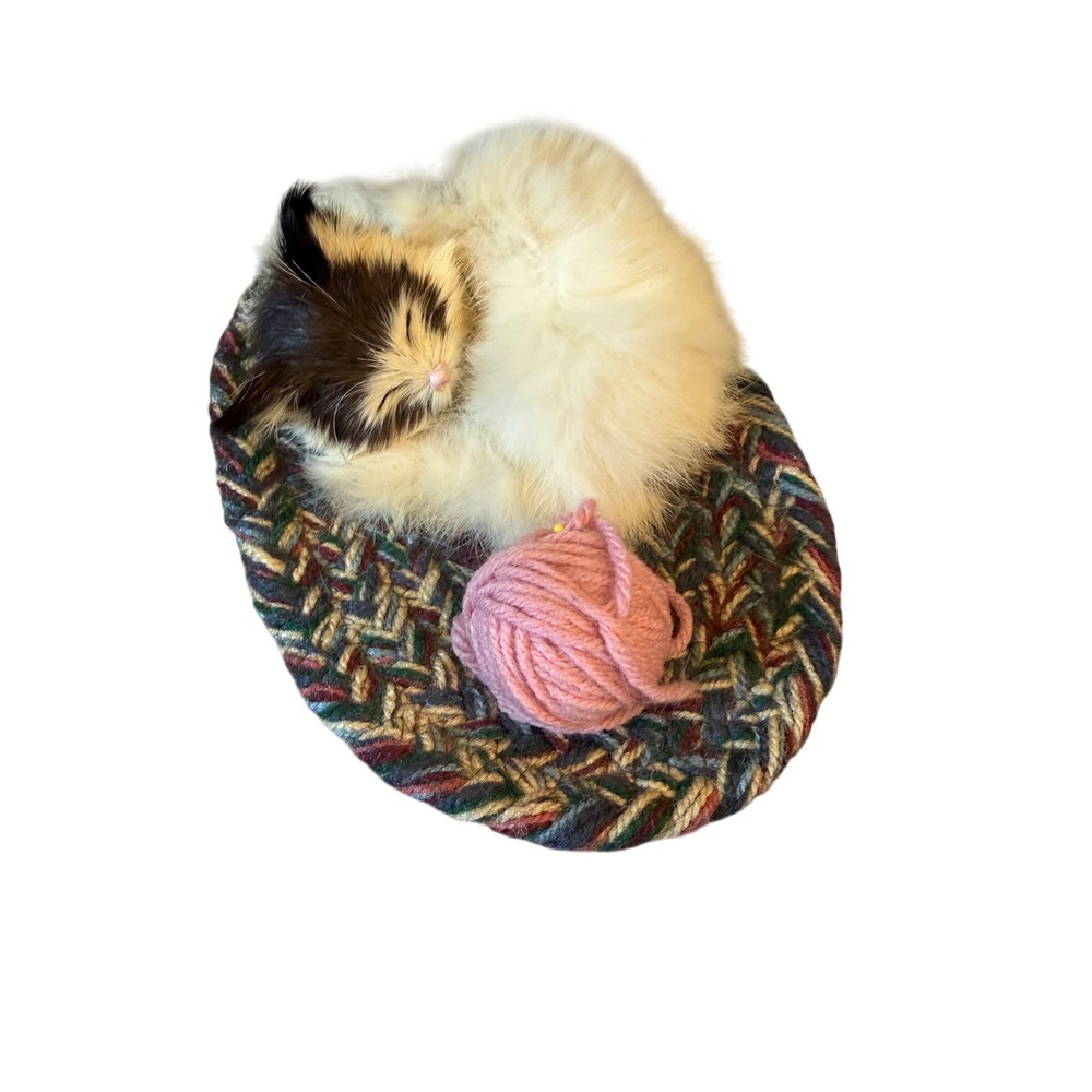 Realistic white and black small curled up sleeping cat with yarn ball decor
